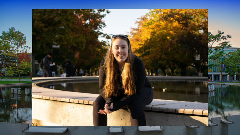 Photo of Meghan Cooke seated at the UBC Fountain.