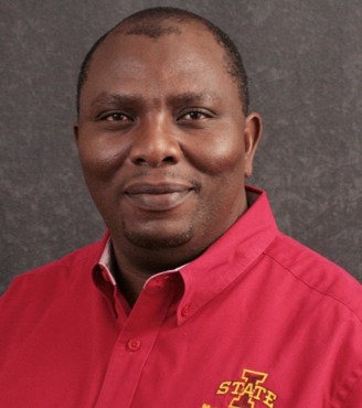 headshot of Martin Thuo in red shirt with brown background